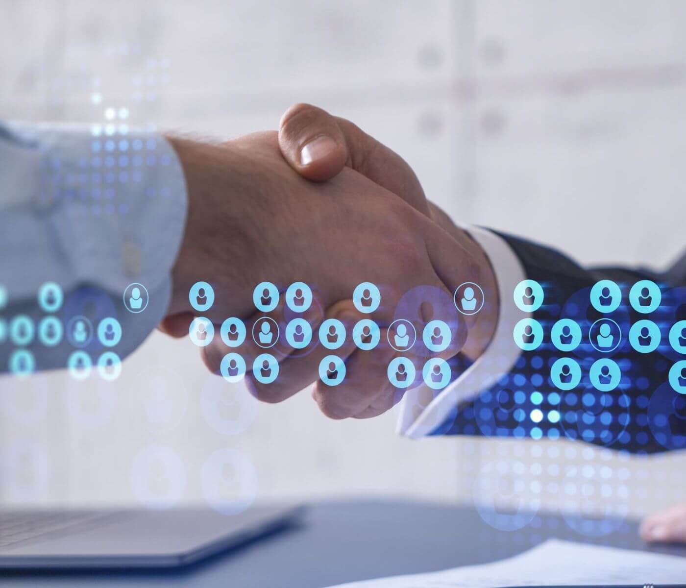 Two business partners shaking hands over a talent strategy